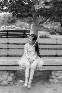 little girl sitting on bench